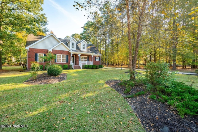 view of front of home with covered porch and a front yard