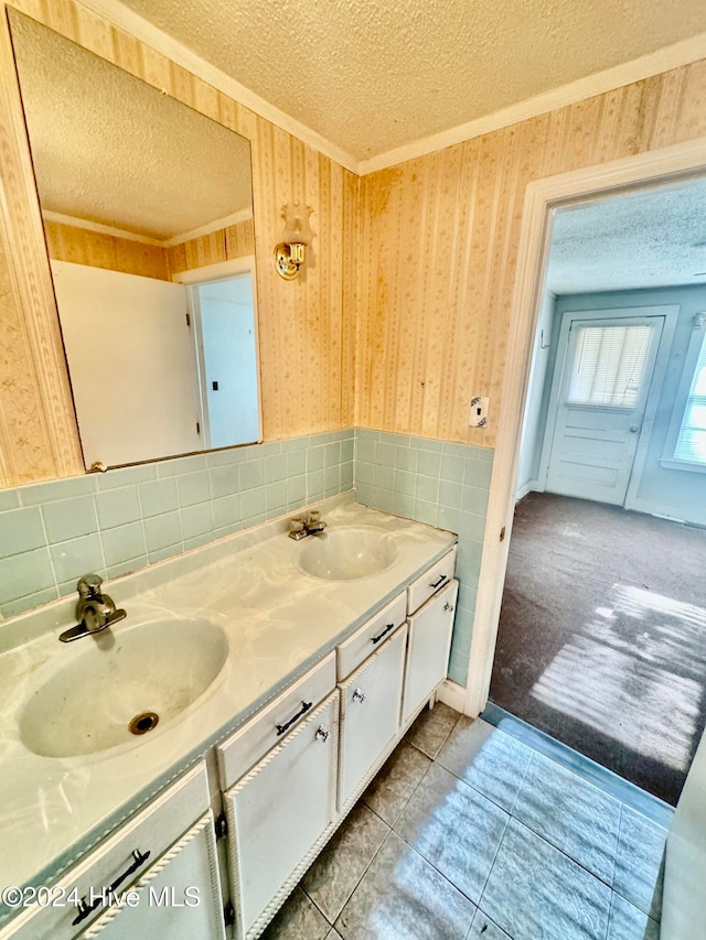 bathroom with vanity, a textured ceiling, and tile patterned flooring