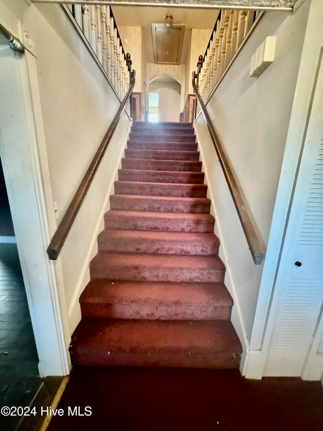 stairs featuring hardwood / wood-style flooring