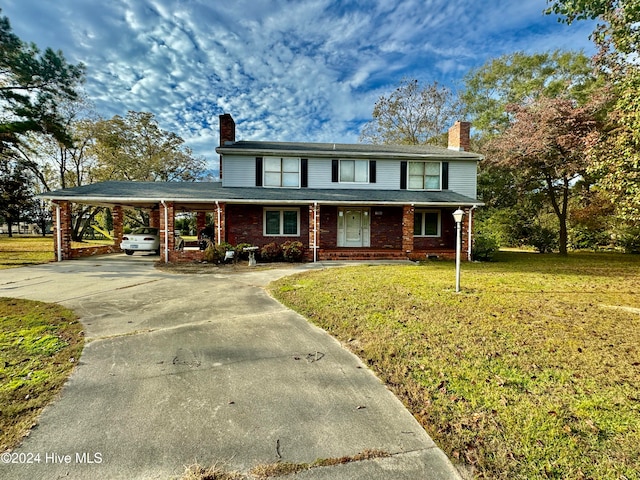 view of front of property featuring a carport and a front yard