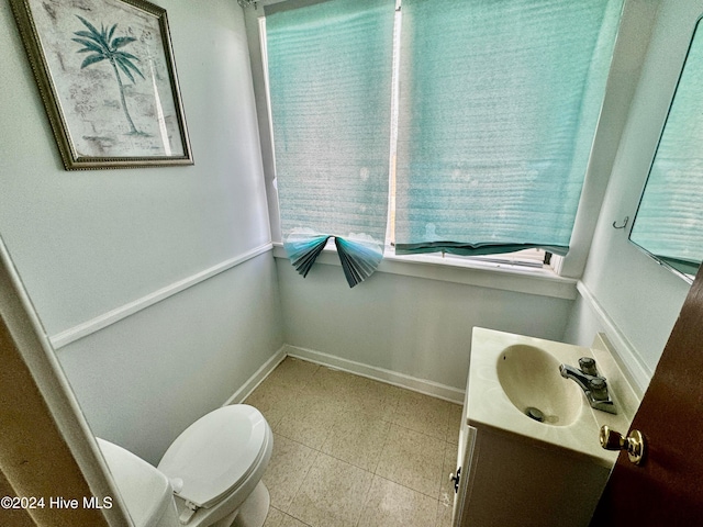 bathroom featuring vanity and toilet