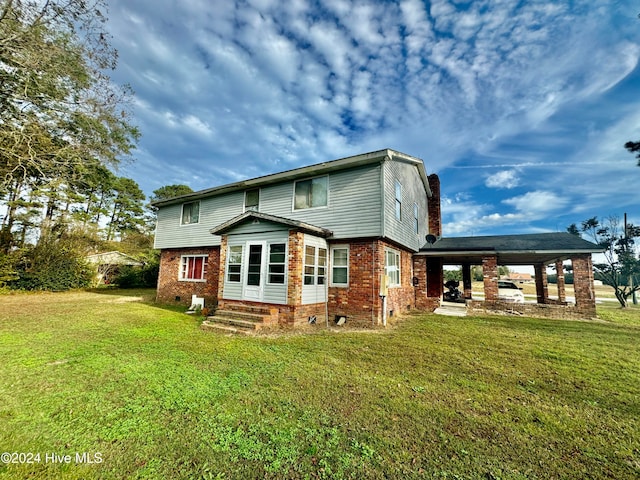 rear view of property with a patio area and a yard