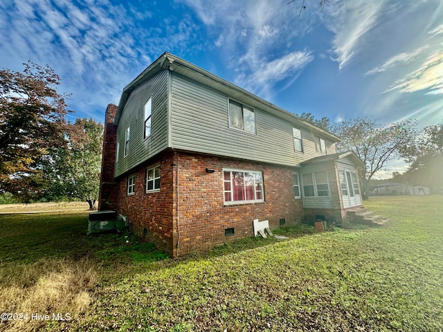 view of property exterior with a lawn