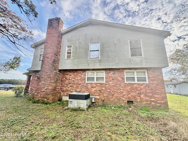 rear view of house with a yard