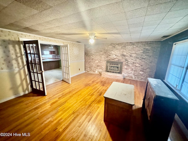 unfurnished living room with hardwood / wood-style floors and ceiling fan