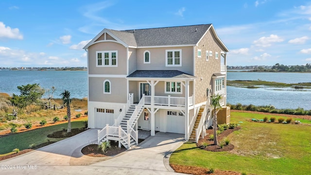 view of front facade featuring a garage, a water view, and a porch