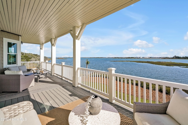 wooden deck with a water view and an outdoor living space