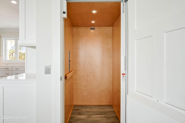 room details featuring hardwood / wood-style flooring and elevator