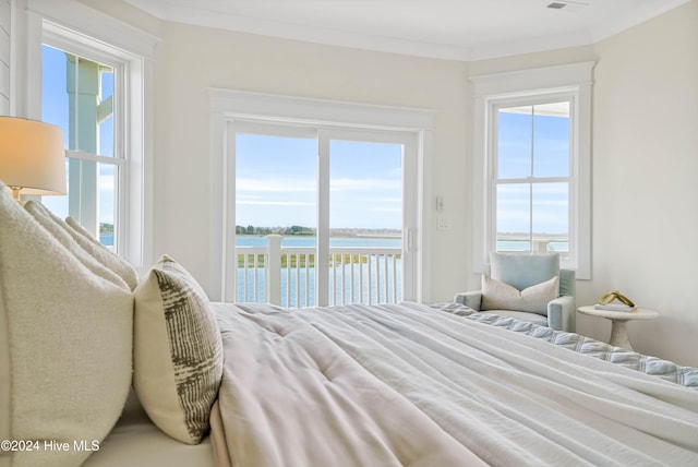 bedroom with access to outside, a water view, multiple windows, and ornamental molding