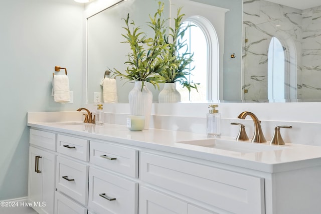 bathroom with vanity and a shower with door