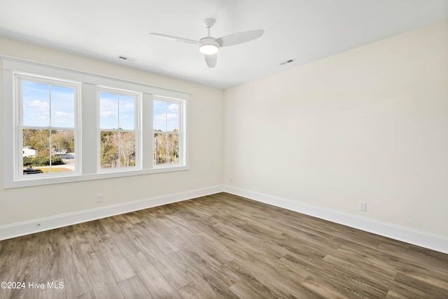 empty room with hardwood / wood-style flooring and ceiling fan