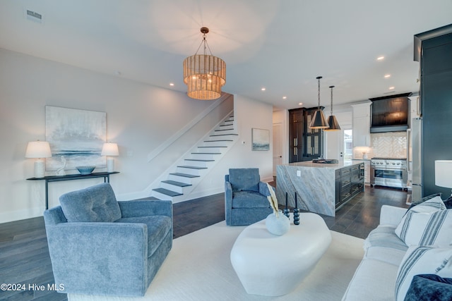 living room featuring an inviting chandelier and dark hardwood / wood-style floors