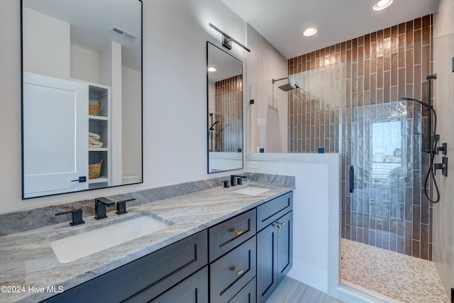 bathroom with vanity and an enclosed shower