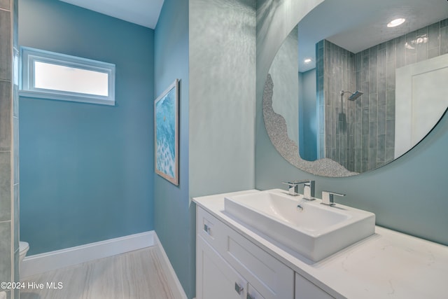 bathroom with vanity and a tile shower