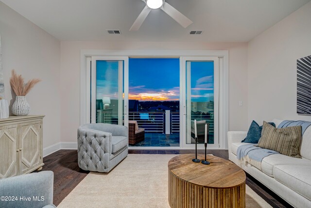 living room featuring hardwood / wood-style floors and ceiling fan