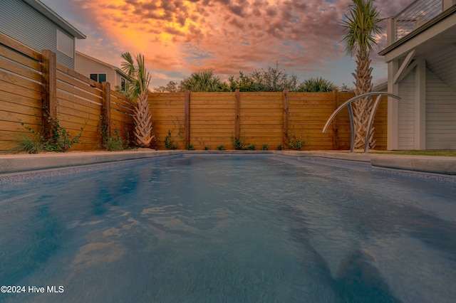 view of pool at dusk