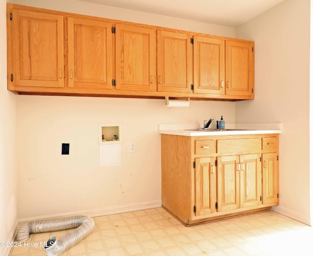 washroom with washer hookup, cabinets, and sink