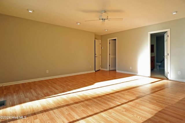 unfurnished room with light wood-type flooring and ceiling fan