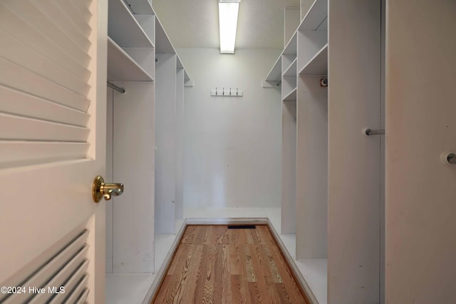 spacious closet featuring light wood-type flooring