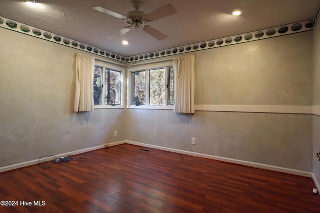 spare room featuring a textured ceiling, dark hardwood / wood-style flooring, and ceiling fan