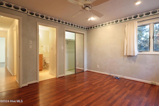 unfurnished bedroom featuring wood-type flooring, a closet, and ceiling fan