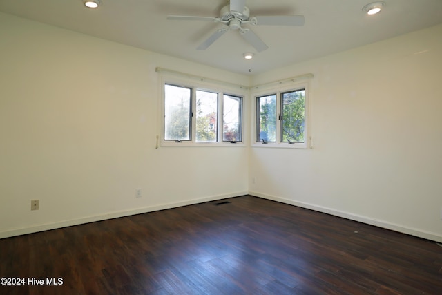 spare room featuring ceiling fan and dark hardwood / wood-style flooring