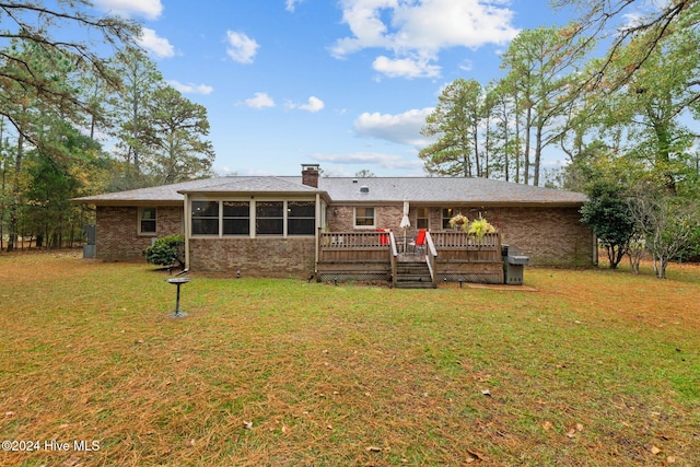 back of house featuring a sunroom, a yard, and a deck