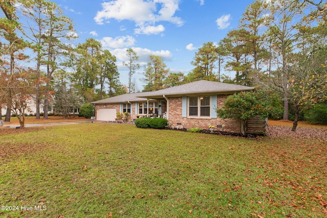 single story home featuring a garage and a front lawn