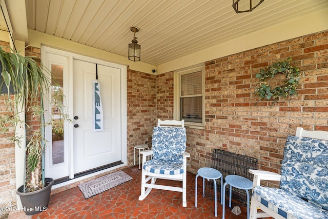 view of exterior entry with a porch