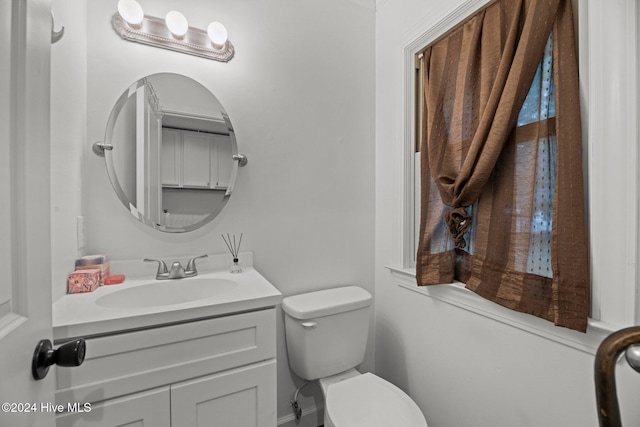 bathroom with toilet and vanity