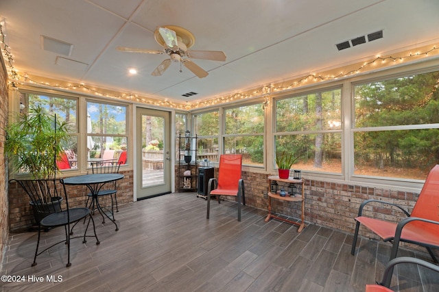 sunroom / solarium featuring ceiling fan