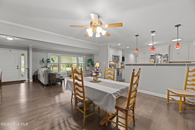 dining space featuring dark hardwood / wood-style flooring, ceiling fan, and crown molding