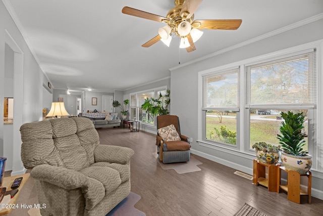 living room featuring ornamental molding, ceiling fan, and dark hardwood / wood-style floors