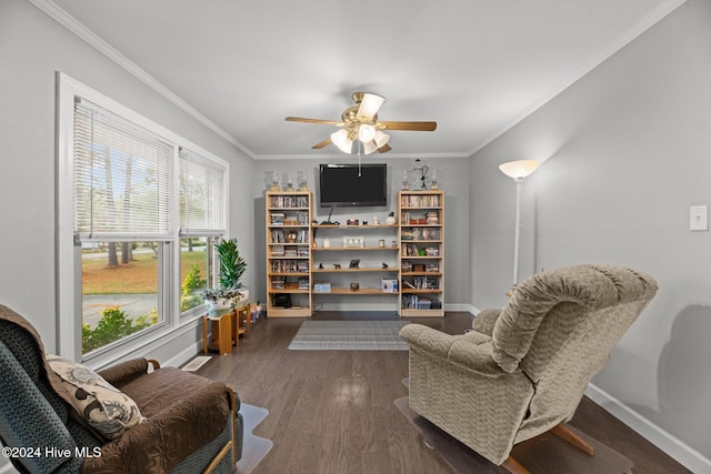 sitting room with ceiling fan, dark hardwood / wood-style floors, and ornamental molding