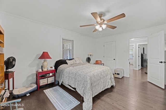 bedroom featuring ornamental molding, multiple windows, dark hardwood / wood-style flooring, and ceiling fan