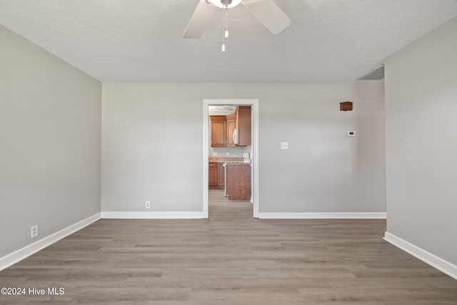 unfurnished room with ceiling fan and light hardwood / wood-style flooring