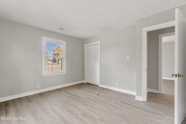 unfurnished room with light wood-type flooring