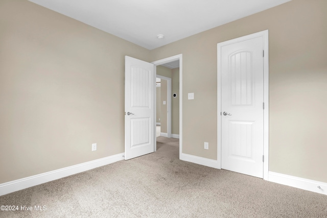 unfurnished bedroom featuring a closet and carpet