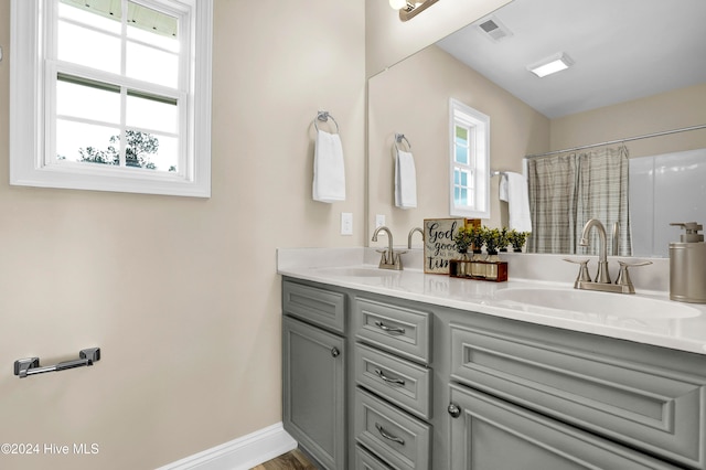 bathroom featuring walk in shower, vanity, and hardwood / wood-style flooring