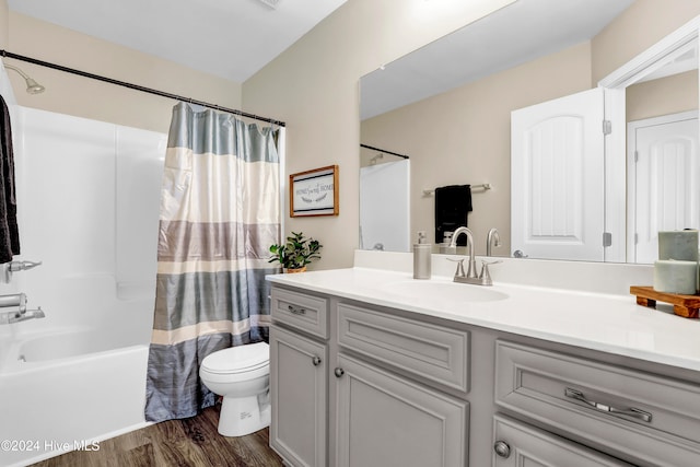 full bathroom with shower / bath combination with curtain, vanity, hardwood / wood-style flooring, and toilet