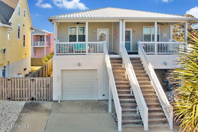 view of front of home featuring a garage, ceiling fan, and a porch