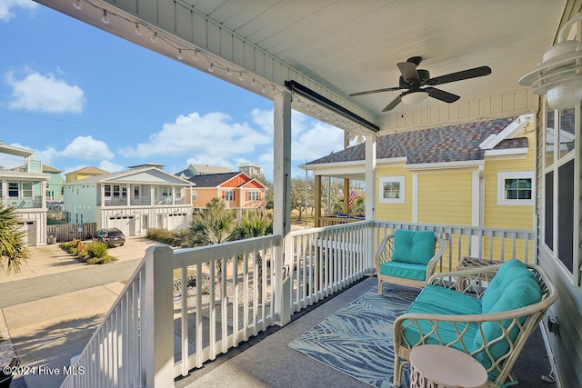 balcony with covered porch and ceiling fan