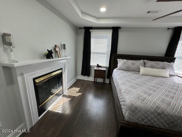 bedroom featuring dark hardwood / wood-style floors and ceiling fan