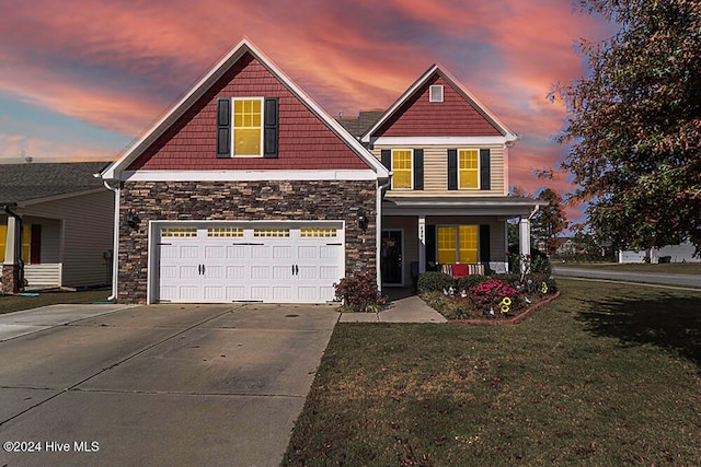 craftsman house featuring a garage, a yard, and a porch