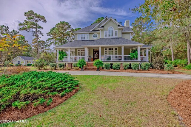 view of side of property featuring a sunroom and a lawn