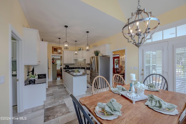 dining area with an inviting chandelier and ornamental molding