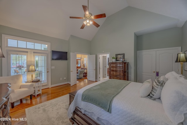 bedroom featuring baseboards, high vaulted ceiling, a ceiling fan, and light wood-style floors