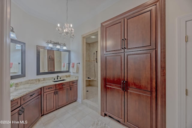 full bathroom with ornamental molding, tile patterned floors, a tile shower, vanity, and a chandelier