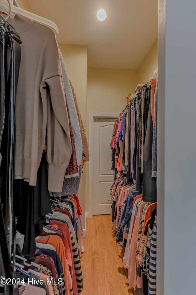 walk in closet with light wood-type flooring