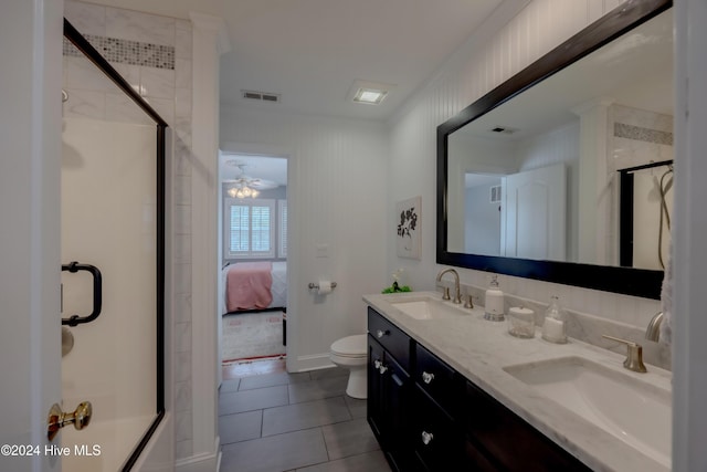 ensuite bathroom featuring tile patterned flooring, visible vents, a sink, and toilet